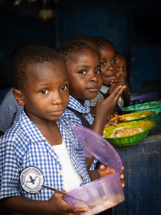 Children eating Mary's Meals school meals